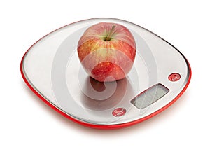 apple on kitchen scales path isolated