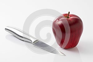 Apple and knife on white