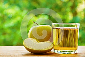 Apple, lobule and glass on the table