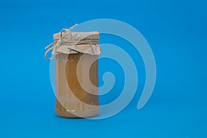 Apple marmelade in a glass jar covered with paper