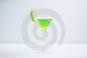 Apple martini cocktail on the white rustic background