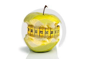 Apple with measuring tape on