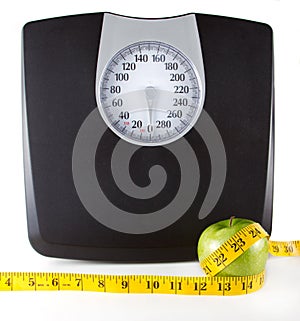 An Apple with a measuring tape and scale