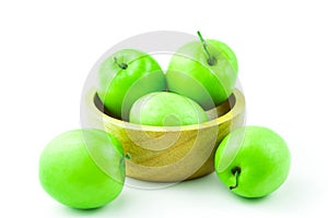 Apple monkey or jujub Zizyphus mauritiana Lam isolated green fruit in wooden cup on white background and clipping path