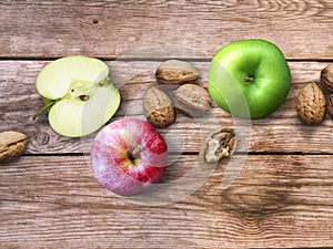 Apple and Nuts Background. Dried walnuts with aple on a wooden background.