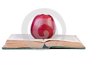 Apple on open old book.