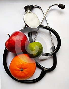 Apple,orange and lemon with stethoscope in white background