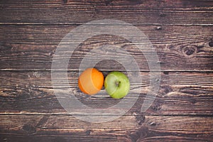 Apple and orange on the table