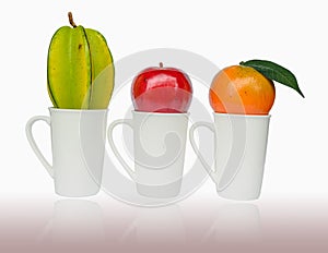 Apple, Orenge and Carambola put on the cup photo