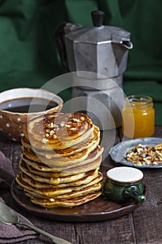 Apple pancakes served with honey, sour cream, nuts, tea and coffee.
