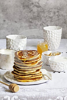 Apple pancakes served with honey, sour cream, nuts, tea and coffee.