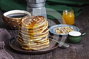 Apple pancakes served with honey, sour cream, nuts, tea and coffee.