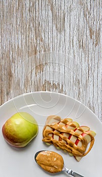 Apple and peanut butter in plate