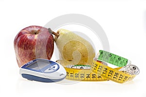 Apple, pear, tape and glucometer