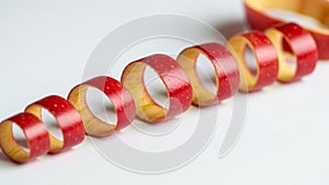 Of apple peel is arranged on a white surface showcasing its red