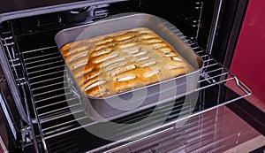 Apple pie on a baking sheet in the oven