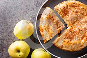 Apple pie with cheese crust closeup in the plate. Horizontal top view