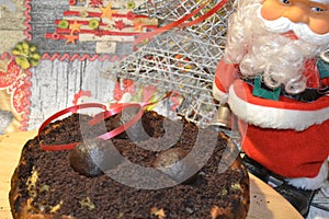 Apple pie with chocolate truffle topping and Santa Claus toy.