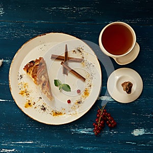 Apple pie with cinnamon on round plate