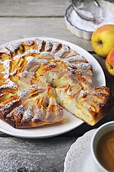 Apple pie and cup of coffee, powdered sugar dressing