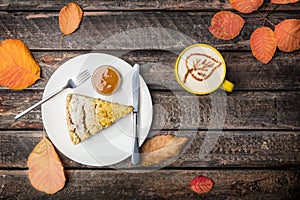 Apple pie with cutlery and coffee on a white dish, on a beautiful wooden background. Top view