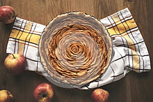 Apple pie in flower shape on wooden table. Traditional dessert