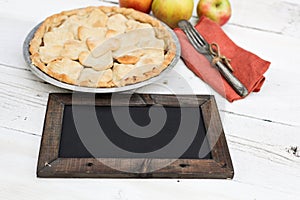 Apple pie with heart shaped crust topping with chalkboard