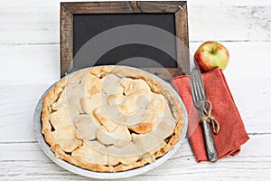 Apple pie with heart shaped crust topping with chalkboard