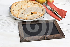 Apple pie with heart shaped crust topping with chalkboard