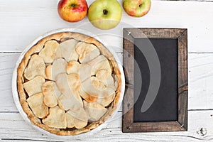 Apple pie with heart shaped crust topping with chalkboard