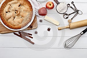 Apple Pie with Ingredients Over Wooden Table Top