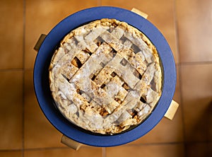 Apple pie with lattice with a blue background