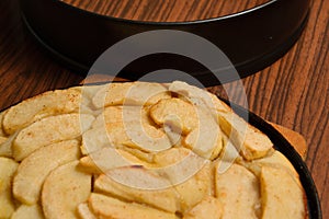 Apple pie near baking tray on table