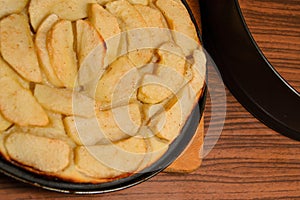 Apple pie near baking tray on table