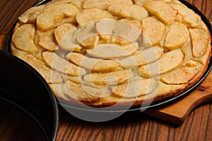 Apple pie near baking tray on table