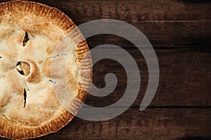 Apple Pie Over a Dark Wooden Table Top