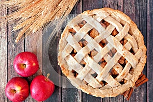 Apple pie overhead table scene on rustic wood