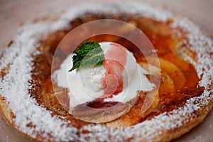 Apple pie on the plate with vanilla ice cream. Restaurant food. Traditional desert.