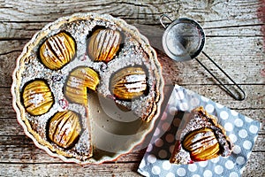 Apple pie, sliced, with whole scored apples and walnut cream filling