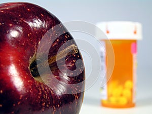 Apple and pill bottle