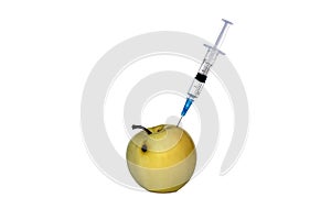 Apple pricked with a syringe on a white isolated background.