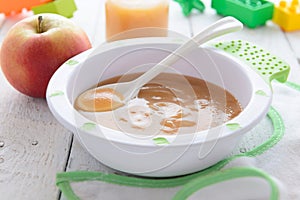 Apple puree in bowl on white table