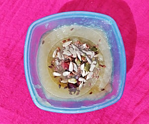 Apple puree with the garnishment of berries and seeds photo