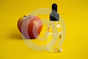 Apple-scented oil. Cosmetic serum with apple extract.