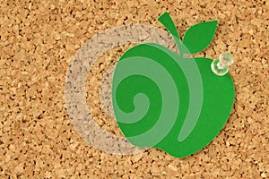 Apple shaped paper note on pinboard