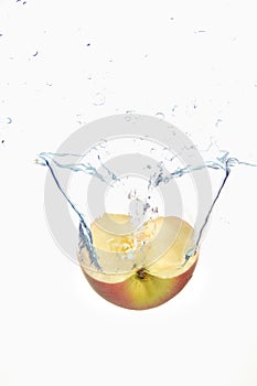 Apple slice spash in water on white background photo