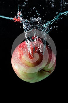 Apple spash in water on black