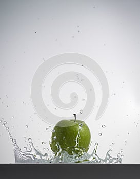 Apple splashing in water