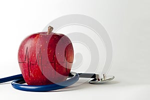 Apple with a stethoscope and cardiogram