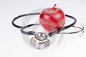 Apple and stethoscope isolated on white